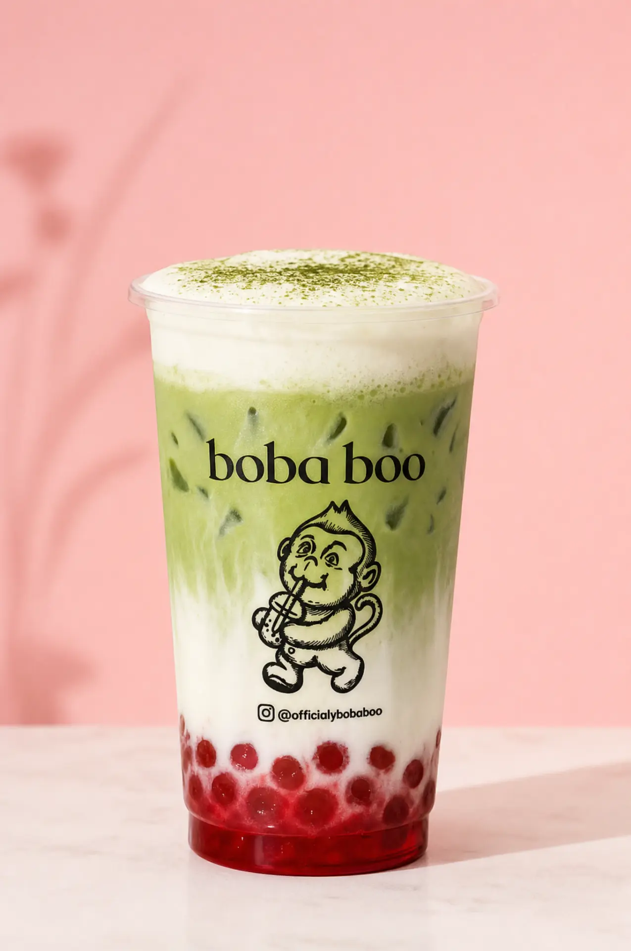 boba boo matcha latte with red popping boba on a pink background — @officiallybobaboo