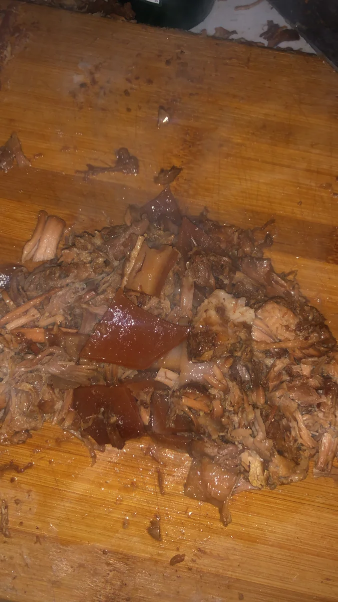 Chopped roasted meat on a wooden cutting board
